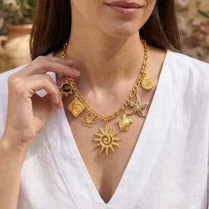 Vue détaillée d'un collier doré avec pendentifs soleil et tortue porté par un mannequin
