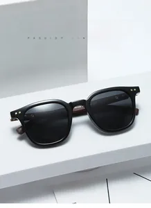 High-quality close-up detail of black sunglasses with wooden temples and metallic rivets.