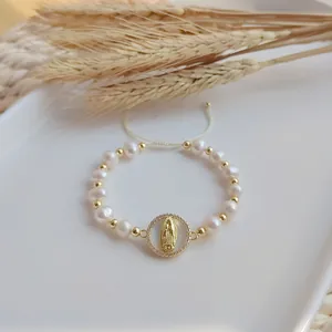 Handmade natural pearl bracelet featuring gold beads and a Virgin Mary medallion charm