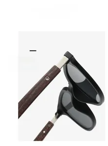Detail view of the stylish wood grain temple and metal hinge of these sun glasses.