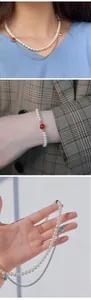 Detailed views showing handmade pearl necklace and bracelet with metal chain accents