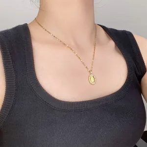 Exquisite 18k gold plated embossed portrait pendant necklace shown on female model.