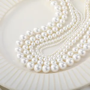 Macro view of lustrous natural white shell pearls in various sizes for DIY jewelry