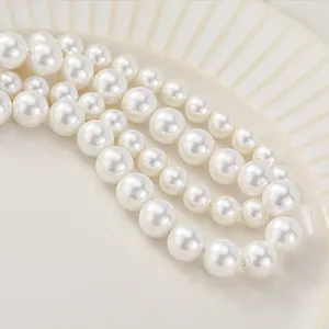 High-quality white shell pearl beads for DIY jewelry making on cream ceramic plate