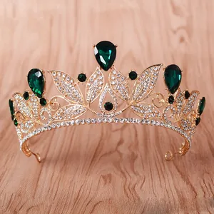 Detailed view of emerald green teardrop crystals on a golden baroque bridal crown