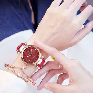 Close-up of women's quartz watch with red glitter dial and matching star bracelet set.
