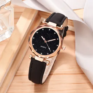Close-up of women's quartz watch with black starry sky dial and rose gold case