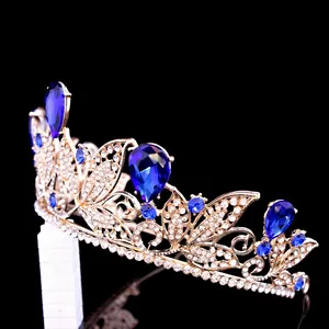 Detailed macro shot of a baroque gold bridal tiara with teardrop blue rhinestones