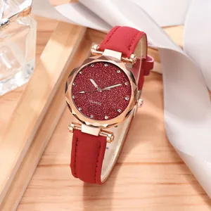 Close-up detail of stylish women's watch with red glitter dial and rose gold case