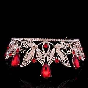 Detailed close-up of a vintage golden baroque bridal crown with sparkling red rhinestones