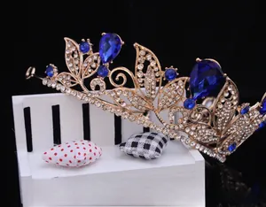 Detail of Baroque gold bridal crown featuring teardrop blue rhinestones and crystals.