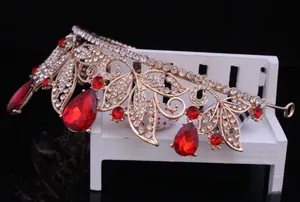 Close-up of vintage Baroque golden bridal tiara featuring elegant red crystal teardrops