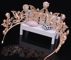 Detailed back view of a vintage golden baroque bridal tiara with red rhinestones