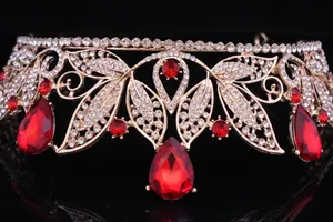Detailed close-up of a vintage golden Baroque bridal tiara with red teardrop crystals