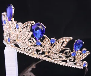 Detailed macro shot of a gold Baroque crown with blue teardrop crystals