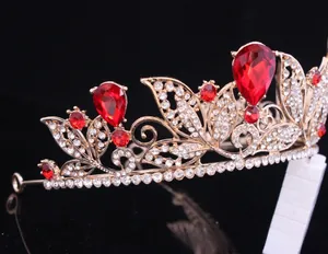 Detailed view of a baroque gold tiara with sparkling red pear-shaped crystals.