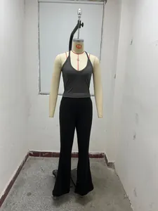 Vue détaillée d'un débardeur gris à col licou et d'un pantalon évasé noir sur un mannequin.