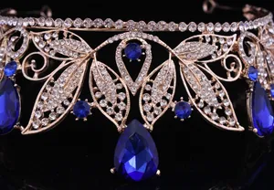 Intricate close-up detail of Baroque gold bridal crown with sparkling blue teardrop crystals