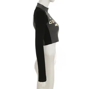 Side view of a grey and black cropped streetwear zipper top with letter print.