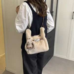 Plush beige handbag with cute bunny charm for autumn and winter Korean style.