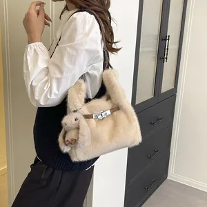 Stylish beige plush handbag with cute rabbit charm and metal buckle for winter