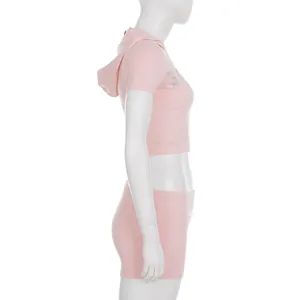 Side profile of pink Y2K style hooded sports set with rhinestone details on mannequin