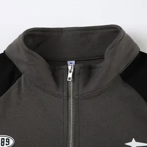 Detail view of grey zip-up collar on a street-style slim fit crop top for women.