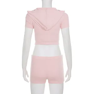 Back view of pink short sleeve hooded crop top and shorts two-piece sports set