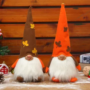 Two plush harvest festival gnomes with maple leaf hats for Thanksgiving decoration