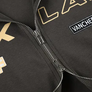 Close-up detail of high-quality metallic zipper and letter print on street style top