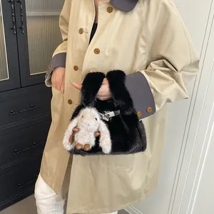 Trendy black fuzzy handbag with a cute rabbit plush charm for autumn and winter outfits