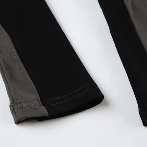 Detailed view of the sleeve cuff with contrast stitching and two-tone knit fabric.