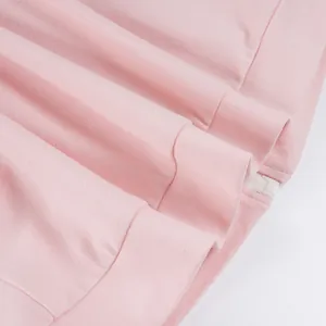 Close-up of pink sports set featuring smooth zipper detail and soft knit fabric.
