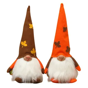Set of two Harvest Festival plush gnomes featuring tall pointed hats and maple leaf decor