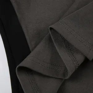 Close-up detail of stitching and fabric texture on a slim fit grey cotton T-shirt.