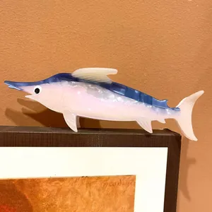 Detailed view of an ocean-themed marlin fish hair claw clip in pearlescent acetate