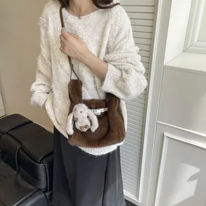 Stylish plush brown crossbody bag with a cute bunny charm for autumn and winter fashion