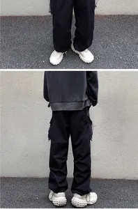 Back view of black high-street cargo pants with drawstring hem and functional pockets