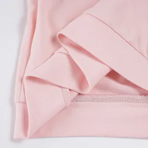 Detail view of pink soft fabric with ribbed hem for athletic two-piece set