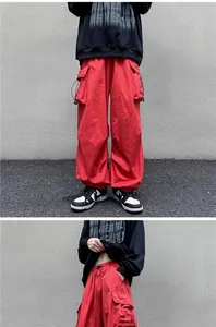 Macro view of red vintage cargo pants with drawstring waist and cargo pocket detail