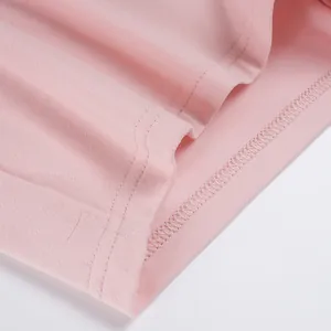 Close-up of double-stitched hem on pink cotton jersey sports top
