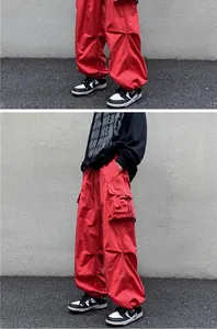 Detail view showing the side pocket and texture of red American vintage cargo pants.