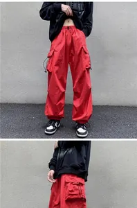 Close-up detail of red high-street vintage cargo pants with functional drawstrings