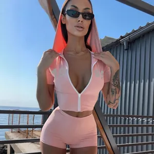 Women's pink two-piece sports set with rhinestone hooded zip crop top and fitted shorts