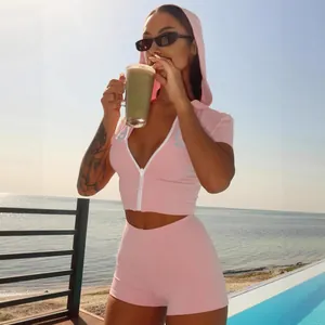 Pink hooded zip-up crop top and matching shorts two-piece sports set for women