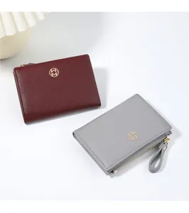 Detailed macro view of two minimalist leather bifold wallets in burgundy and grey