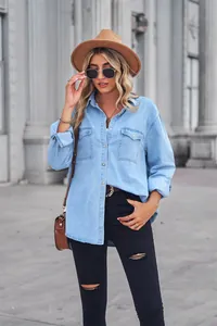 Stylish model posing in a light blue denim long-sleeved shirt with double chest pockets.