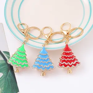 Detailed view of enamel Christmas tree keychains with rhinestones in green, blue, and red