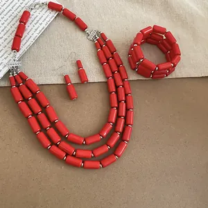 Close-up of red multi-strand bead necklace, matching bracelet and drop earrings set
