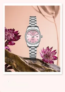 Elegant ladies quartz watch with pink dial and crystal bezel displayed on rustic wood